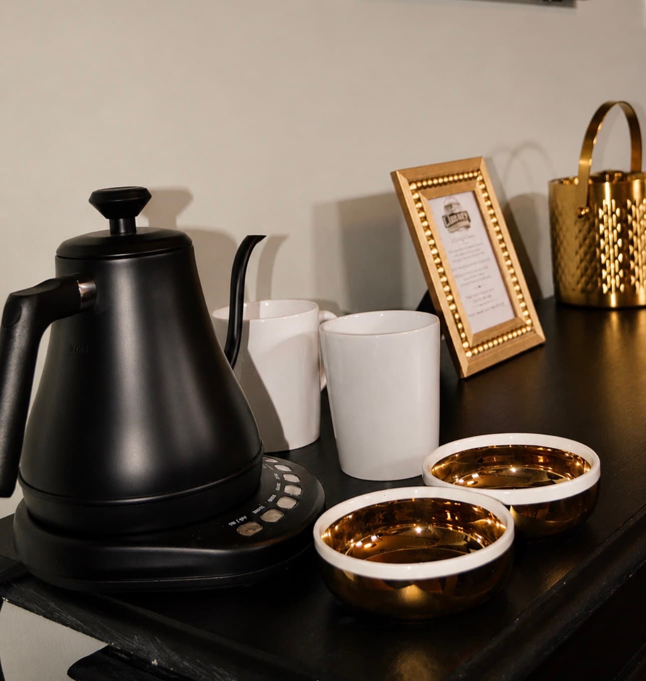 Gooseneck kettle, mugs, and curated teas set up in a Library Historic Hotel suite